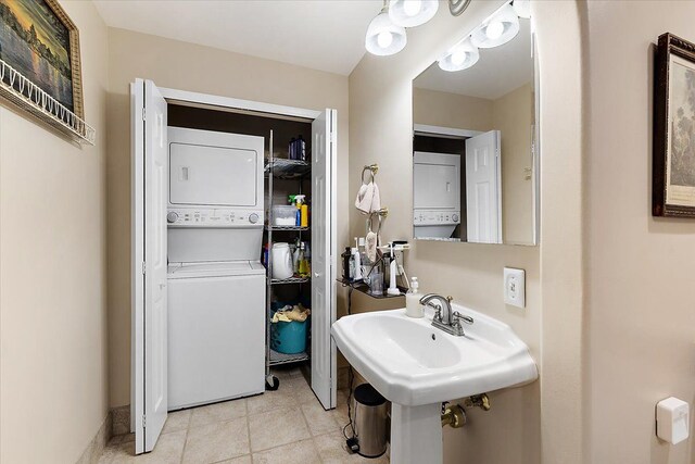 5400 Grange Hall Rd, Holly, MI 48442 - bathroom with tile patterned floors, stacked washer / dryer, and a sink