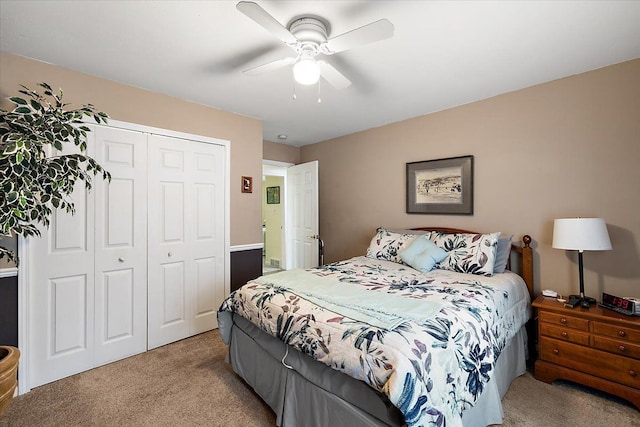 carpeted bedroom featuring a closet and ceiling fan