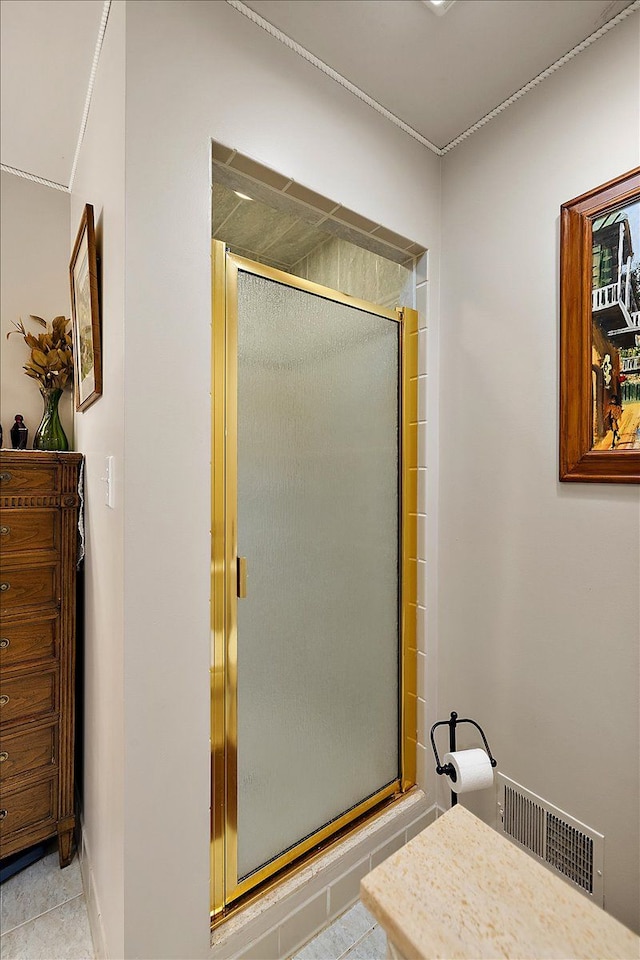 bathroom featuring tile patterned flooring and a shower with shower door