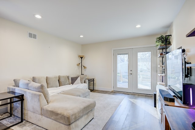 living room featuring french doors and light wood-type flooring