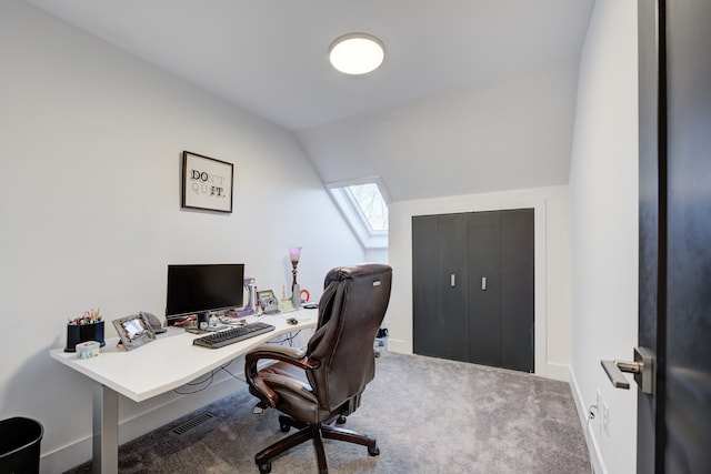 carpeted office space featuring vaulted ceiling