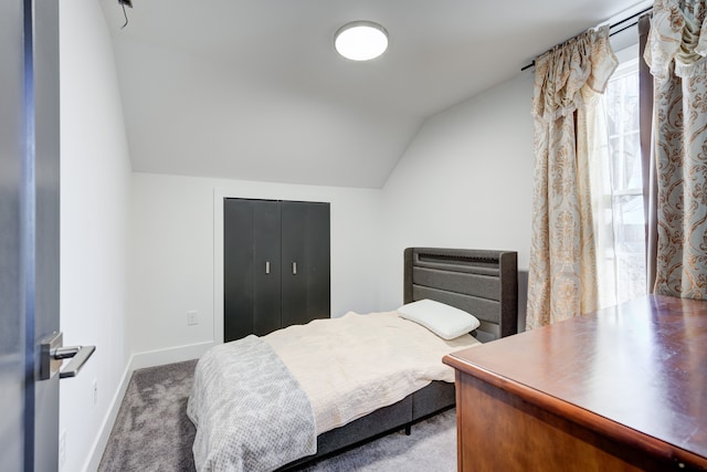 bedroom with carpet flooring and lofted ceiling