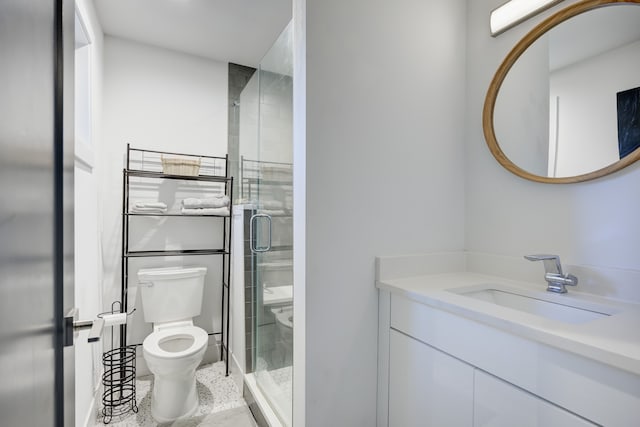 bathroom featuring vanity, toilet, and walk in shower