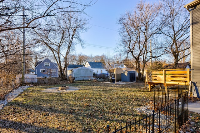 view of yard with a fire pit and a storage shed