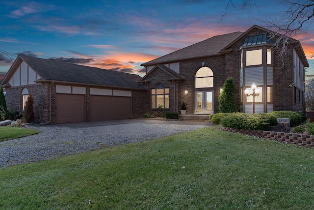 view of front of house with a yard, french doors, and a garage