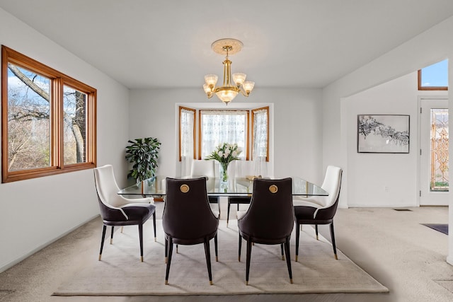 dining room featuring carpet floors and an inviting chandelier