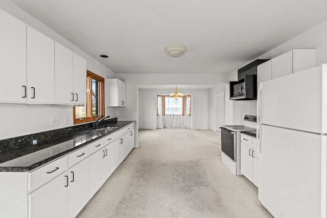 kitchen featuring white appliances, light colored carpet, sink, an inviting chandelier, and white cabinetry