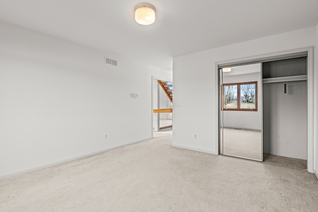 unfurnished bedroom featuring carpet and a closet