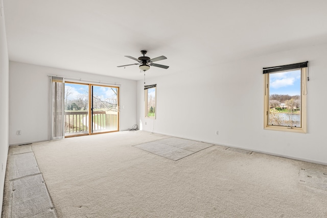 unfurnished room featuring light colored carpet and ceiling fan