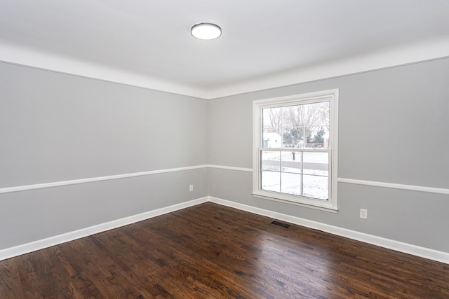 spare room featuring dark hardwood / wood-style floors