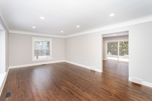 spare room featuring dark wood-type flooring