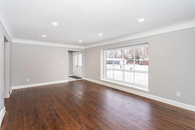 unfurnished living room with dark wood-type flooring