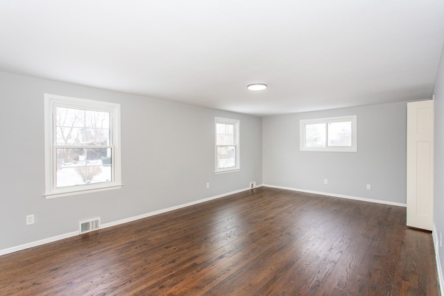 spare room with dark hardwood / wood-style flooring