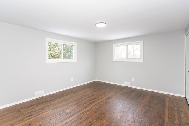 empty room featuring dark hardwood / wood-style flooring