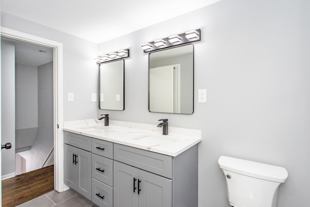 bathroom with vanity, tile patterned floors, and toilet