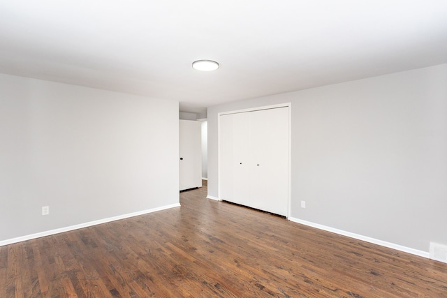 unfurnished room featuring dark hardwood / wood-style floors