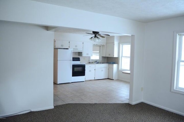 kitchen with white appliances, light colored carpet, ceiling fan, sink, and white cabinets