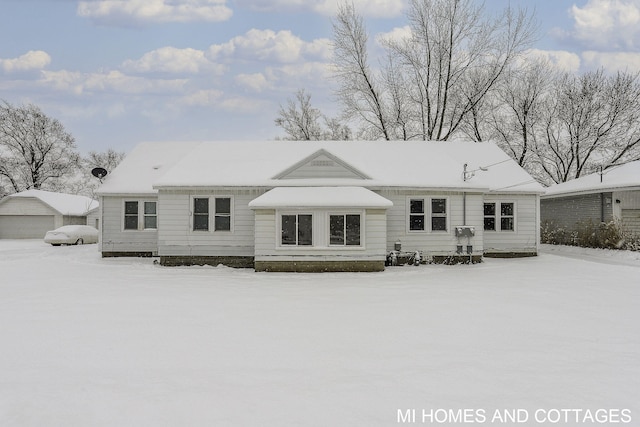 view of snow covered rear of property