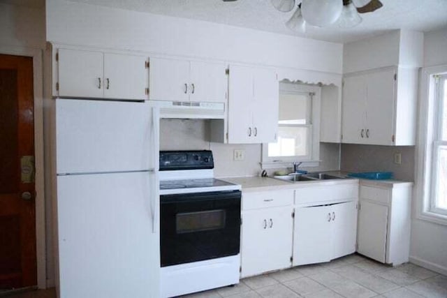 kitchen featuring white appliances, white cabinetry, ceiling fan, and sink