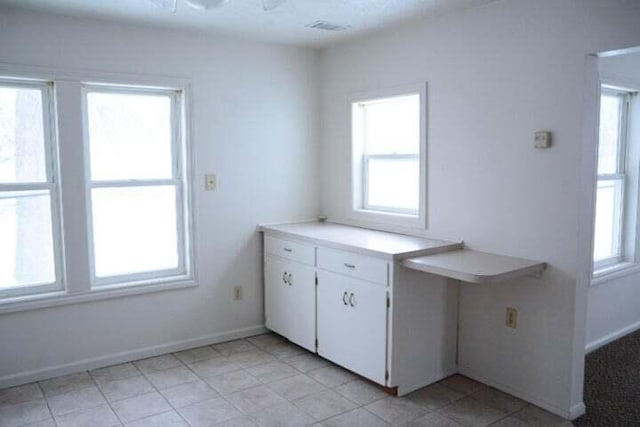 kitchen with white cabinets and plenty of natural light