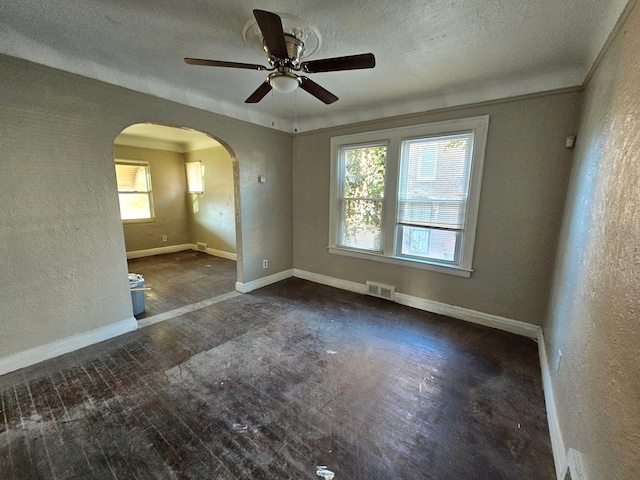 spare room with ceiling fan and a textured ceiling