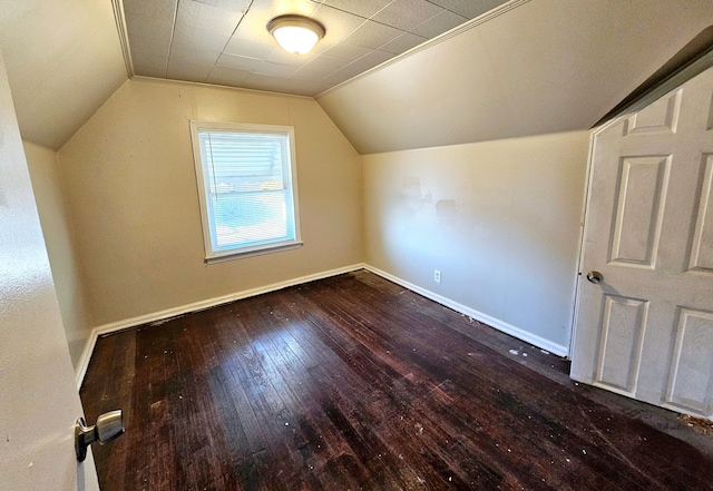 additional living space with wood-type flooring and vaulted ceiling