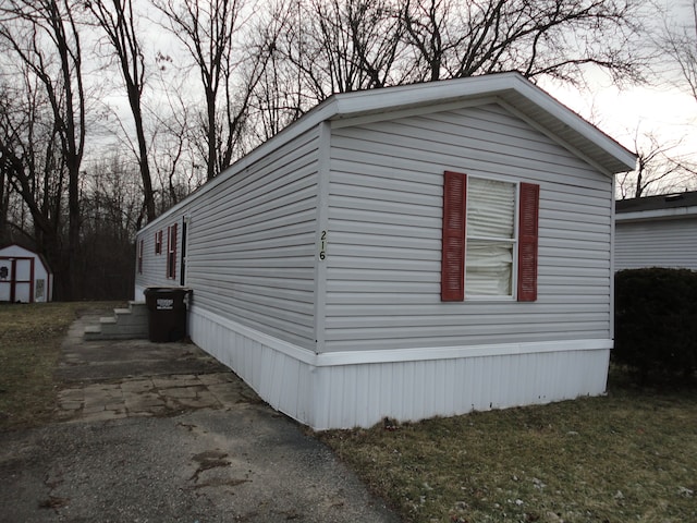 view of home's exterior with a storage shed