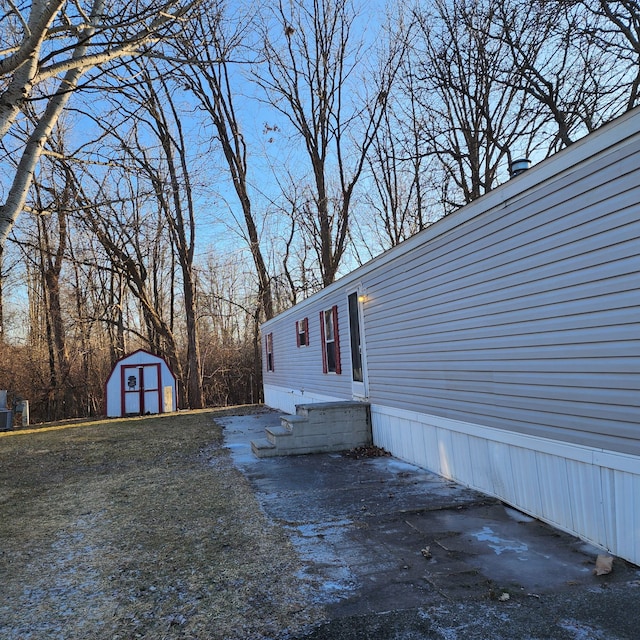 view of property exterior featuring a storage unit