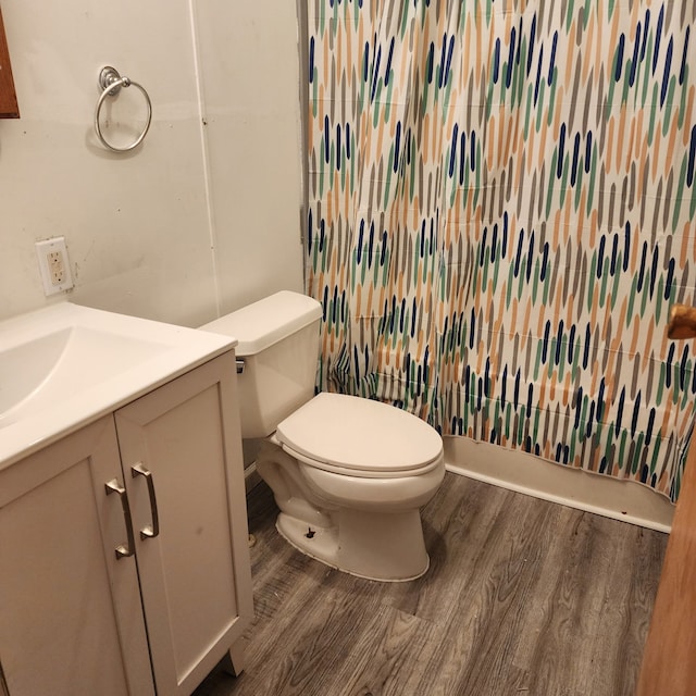 bathroom with hardwood / wood-style flooring, vanity, and toilet