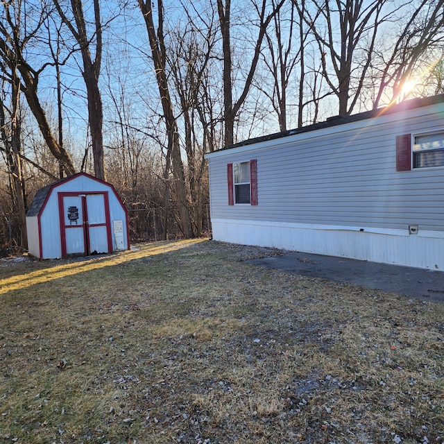 exterior space featuring a yard and a storage unit