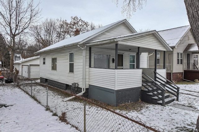 view of front facade with a garage and an outbuilding