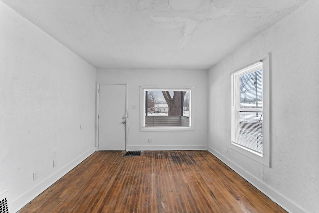 empty room featuring dark hardwood / wood-style flooring