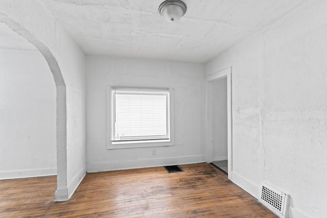 spare room featuring dark hardwood / wood-style floors