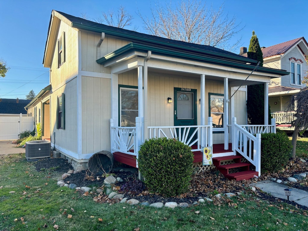 view of front of house with covered porch and central AC unit