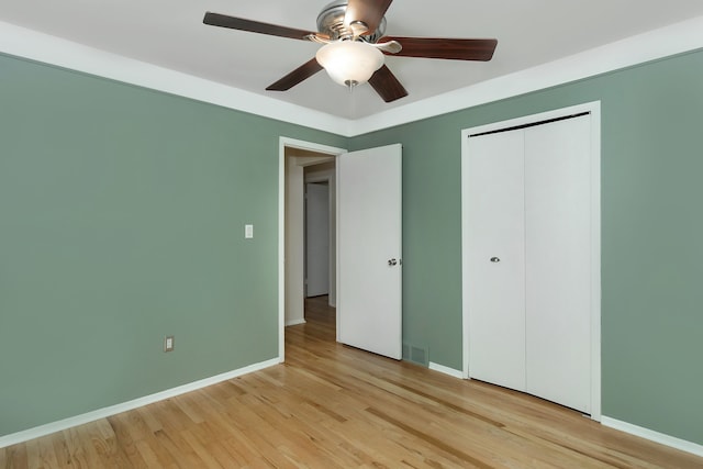 unfurnished bedroom with a closet, ceiling fan, and light wood-type flooring