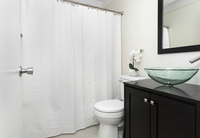 bathroom featuring tile patterned floors, vanity, and toilet