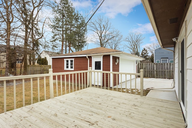 wooden terrace with an outbuilding, a yard, and a garage