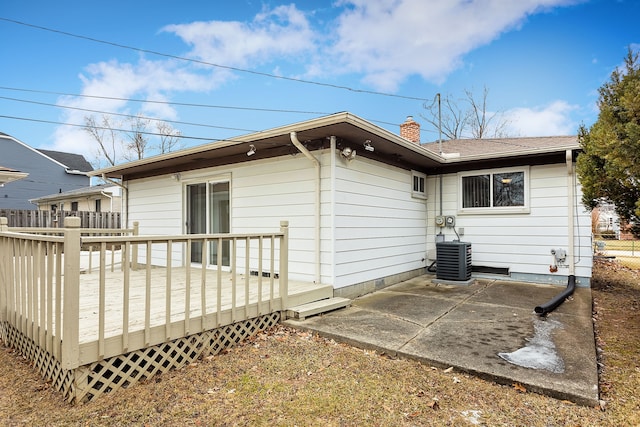 back of house featuring a wooden deck, a patio, and central air condition unit