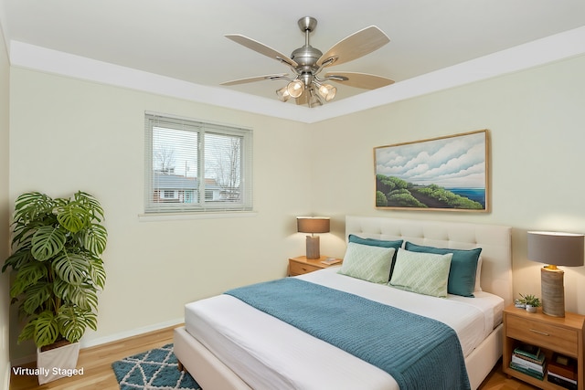 bedroom with ceiling fan and hardwood / wood-style floors