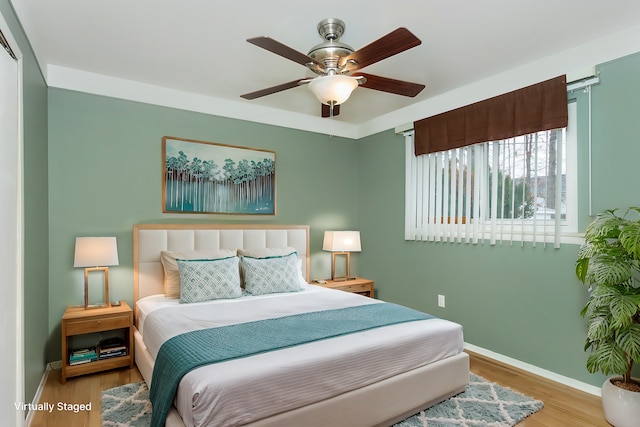 bedroom with ceiling fan and light hardwood / wood-style flooring