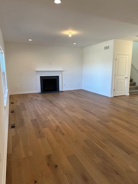 unfurnished living room featuring hardwood / wood-style floors