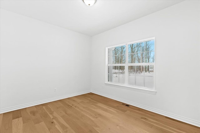 spare room featuring light hardwood / wood-style flooring