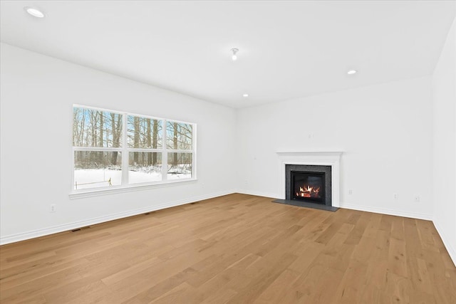 unfurnished living room with light hardwood / wood-style floors