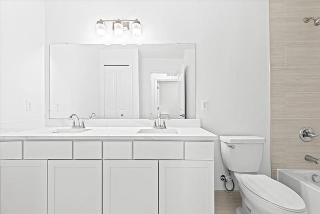 full bathroom featuring vanity, toilet, and tiled shower / bath combo