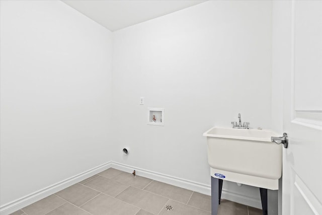 clothes washing area featuring washer hookup and light tile patterned flooring