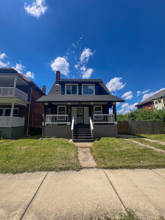 bungalow-style house featuring a front lawn and covered porch