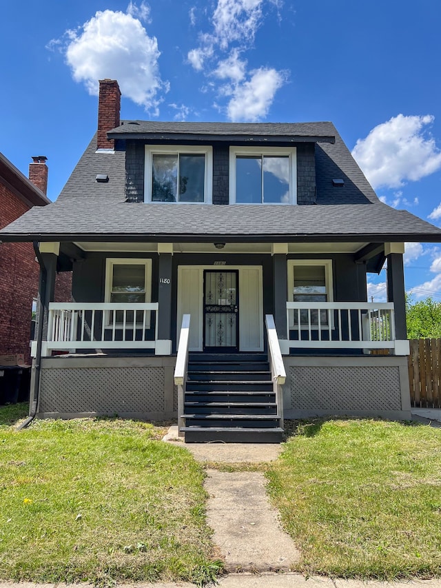 bungalow-style house with covered porch and a front yard