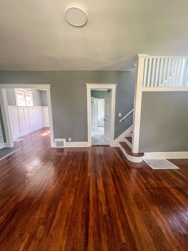 unfurnished living room featuring dark hardwood / wood-style flooring