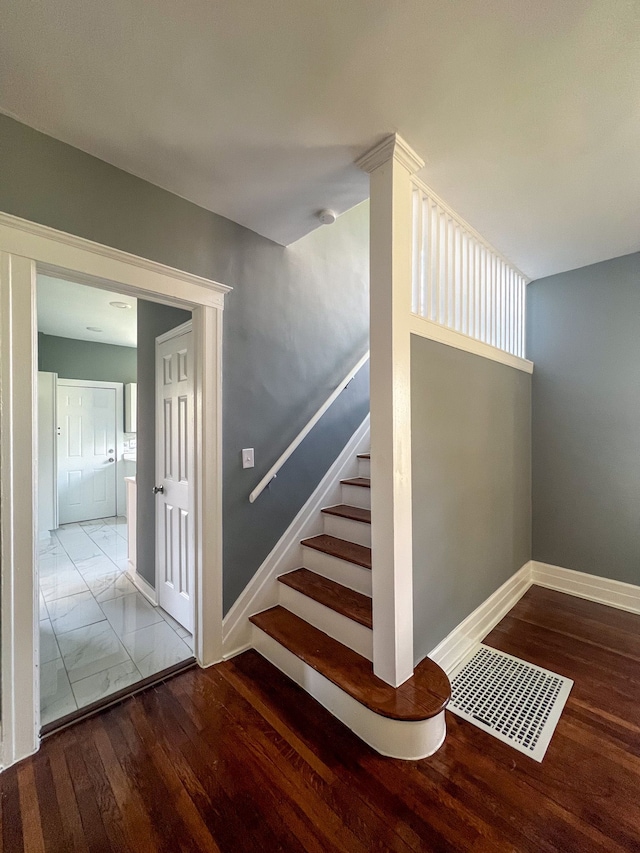 stairs with hardwood / wood-style floors