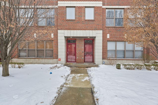 view of snow covered property entrance